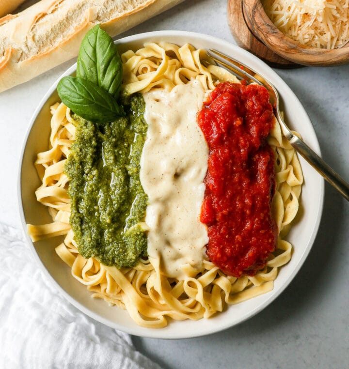 This Christmas Pasta is made with three popular sauces -- alfredo sauce, marinara sauce, and pesto sauce -- all tossed together with pasta. This Alfredo, Marinara, and Pesto Sauce Pasta is a surefire hit!