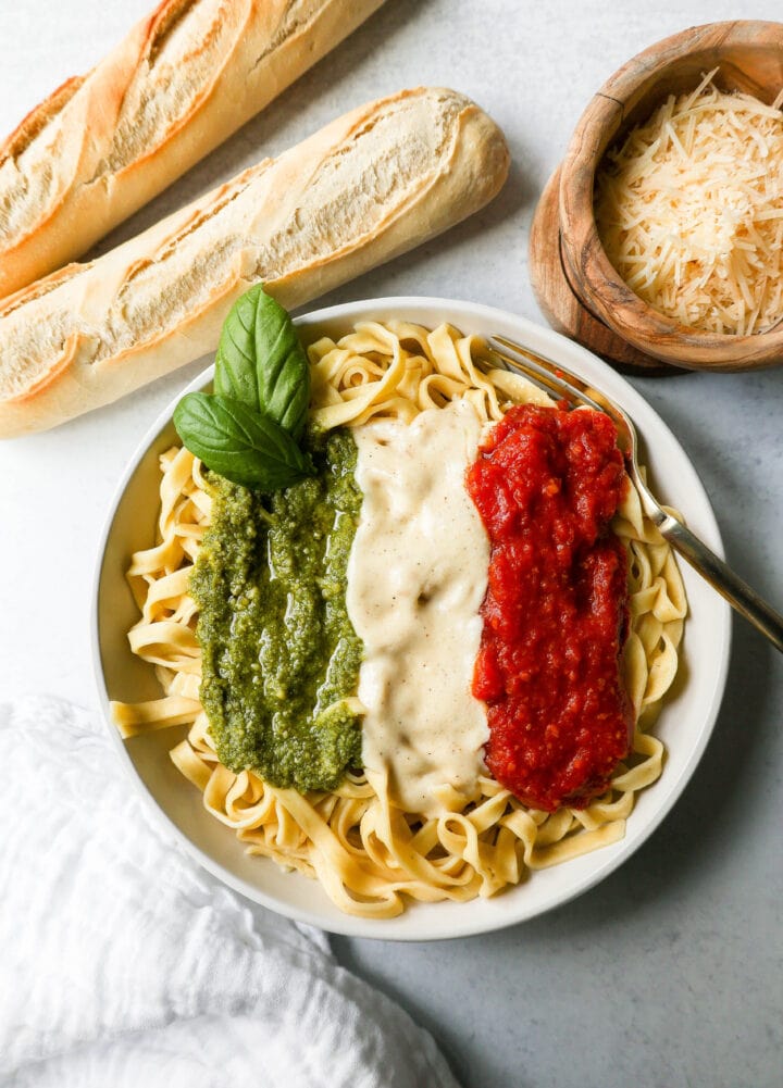 This Christmas Pasta is made with three popular sauces -- alfredo sauce, marinara sauce, and pesto sauce -- all tossed together with pasta. This Alfredo, Marinara, and Pesto Sauce Pasta is a surefire hit!