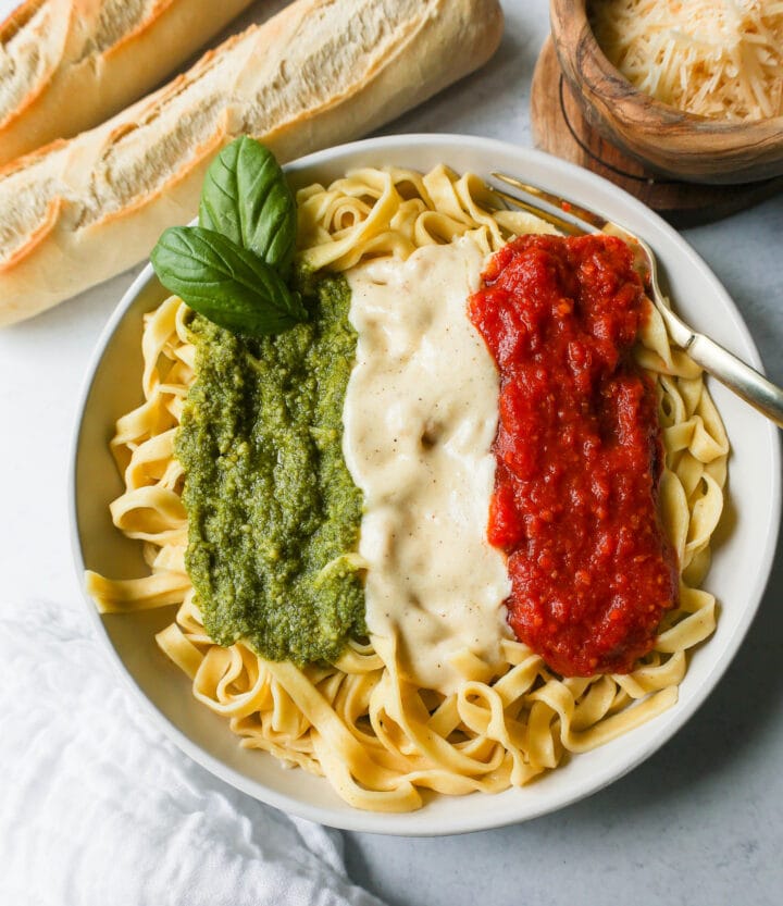 This Christmas Pasta is made with three popular sauces -- alfredo sauce, marinara sauce, and pesto sauce -- all tossed together with pasta. This Alfredo, Marinara, and Pesto Sauce Pasta is a surefire hit!