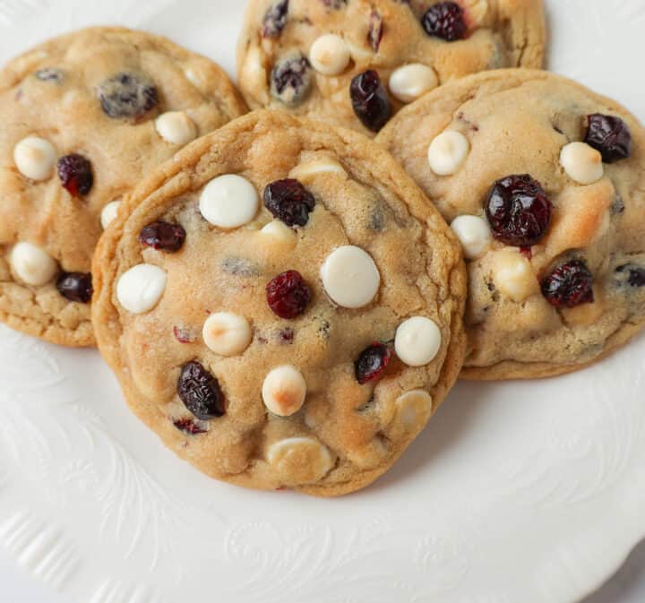 Soft Cranberry White Chocolate Chip Cookies are perfectly chewy with buttery crispy edges filled with sweet dried cranberries and creamy white chocolate chip chips. The Best White Chocolate Chip Cookie Recipe!