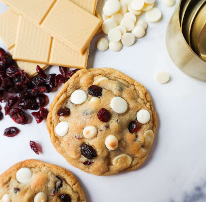 Soft Cranberry White Chocolate Chip Cookies are perfectly chewy with buttery crispy edges filled with sweet dried cranberries and creamy white chocolate chip chips. The Best White Chocolate Chip Cookie Recipe!