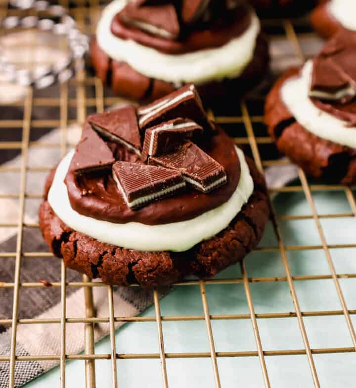 Frosted Mint Chocolate Brownie Cookies are made with a chewy double chocolate cookie, topped with creamy mint frosting, chocolate ganache, and Andes mints. These Andes Mint Cookies are the perfect holiday mint chocolate cookie recipe!