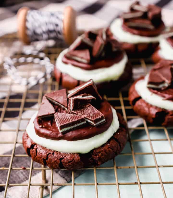 Frosted Mint Chocolate Brownie Cookies are made with a chewy double chocolate cookie, topped with creamy mint frosting, chocolate ganache, and Andes mints. These Andes Mint Cookies are the perfect holiday mint chocolate cookie recipe!