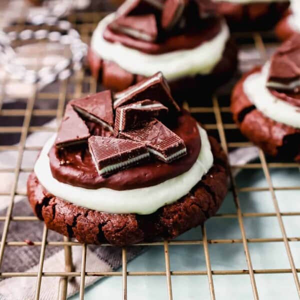 Frosted Mint Chocolate Brownie Cookies are made with a chewy double chocolate cookie, topped with creamy mint frosting, chocolate ganache, and Andes mints. These Andes Mint Cookies are the perfect holiday mint chocolate cookie recipe!