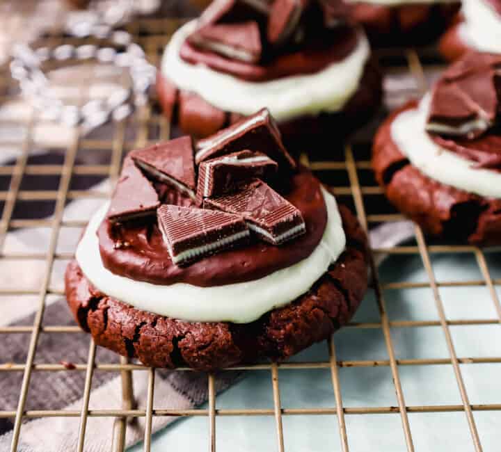 Frosted Mint Chocolate Brownie Cookies are made with a chewy double chocolate cookie, topped with creamy mint frosting, chocolate ganache, and Andes mints. These Andes Mint Cookies are the perfect holiday mint chocolate cookie recipe!