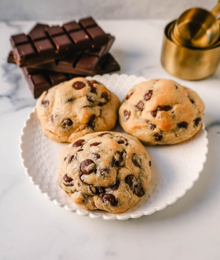 Levain Bakery Two Chip Chocolate Chip Cookie Recipe is their classic chocolate chip cookie made without nuts. Perfectly crispy on the outside and satisfyingly thick and gooey in the center, this cookie is brimming with semi-sweet and dark chocolate chips.