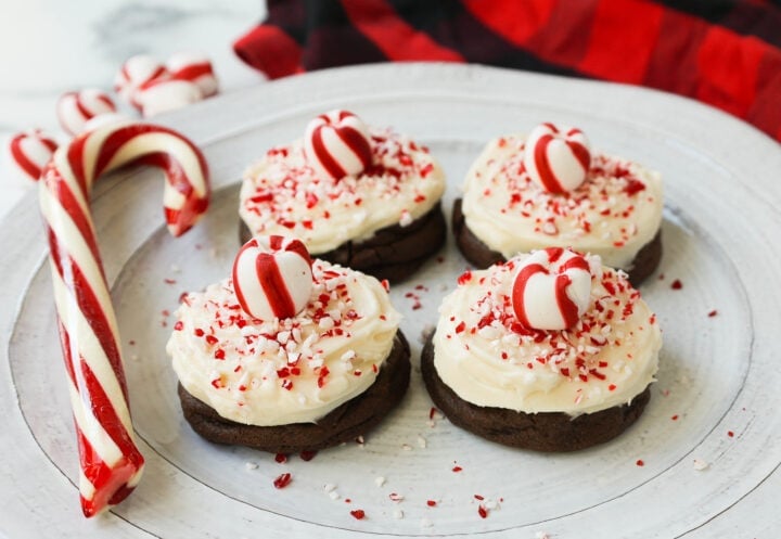 Soft, decadent chocolate cookies topped with homemade creamy peppermint frosting and crushed candy canes. The perfect peppermint frosted chocolate cookie recipe! A delicious peppermint and chocolate Christmas cookie.