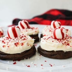 Soft, decadent chocolate cookies topped with homemade creamy peppermint frosting and crushed candy canes. The perfect peppermint frosted chocolate cookie recipe! A delicious peppermint and chocolate Christmas cookie.