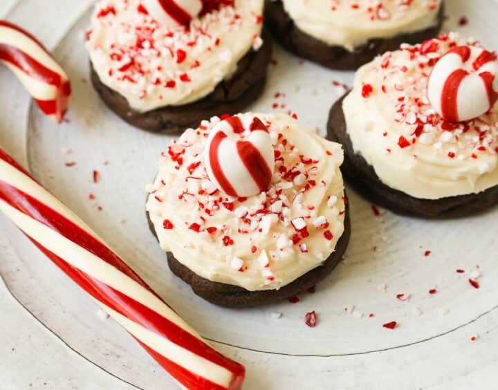 Soft, decadent chocolate cookies topped with homemade creamy peppermint frosting and crushed candy canes. The perfect peppermint frosted chocolate cookie recipe! A delicious peppermint and chocolate Christmas cookie.