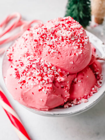 Creamy Homemade Peppermint Ice Cream made with heavy cream, milk, sugar, peppermint extract, and crushed candy canes (or peppermint bark for homemade peppermint bark ice cream). This is the best peppermint ice cream recipe!