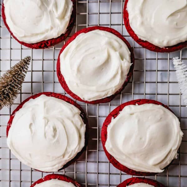 Soft, chewy homemade red velvet cookies topped with a sweet cream cheese frosting. A festive and delicious Christmas cookie recipe!