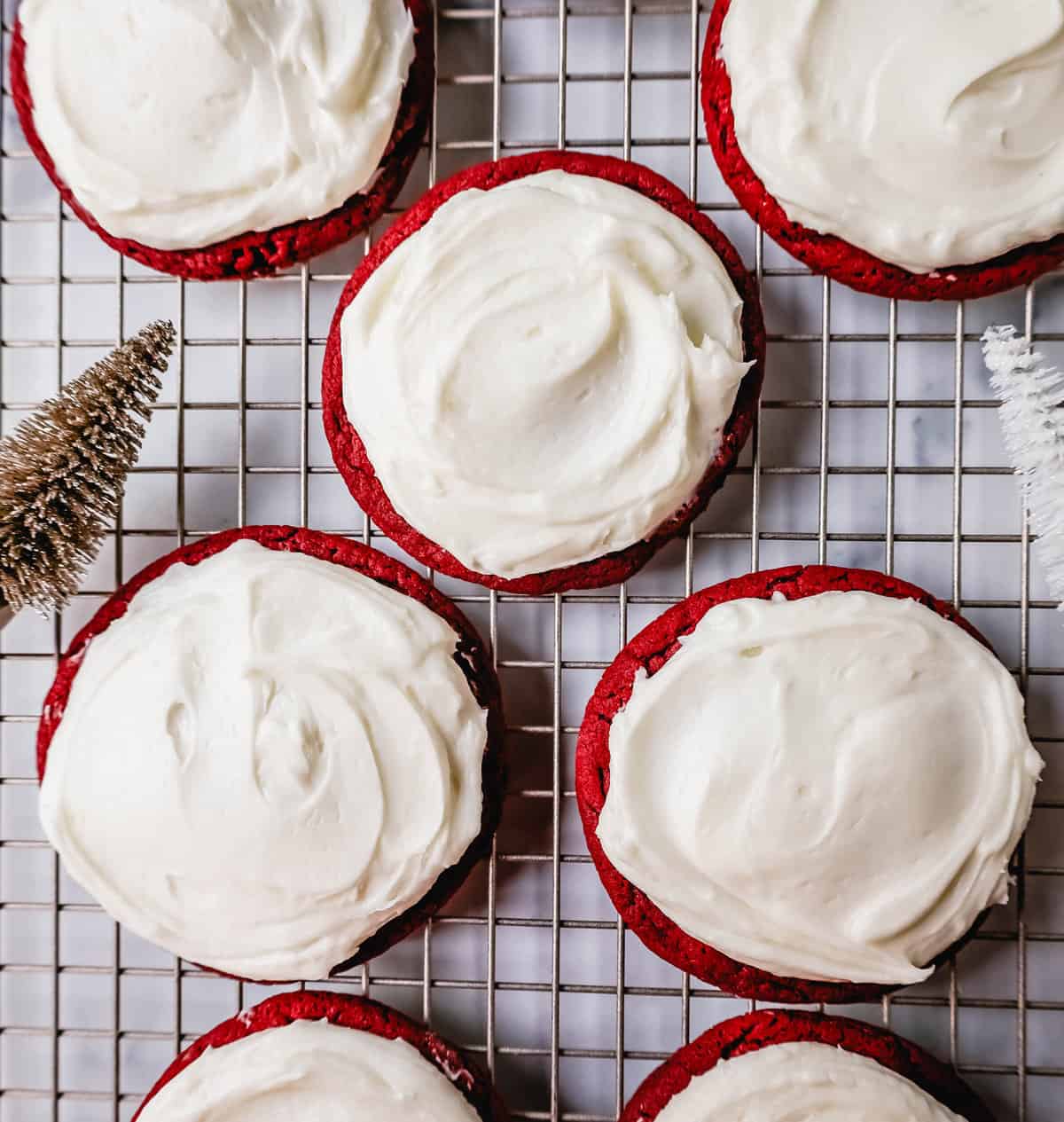 Soft, chewy homemade red velvet cookies topped with a sweet cream cheese frosting. A festive and delicious Christmas cookie recipe!