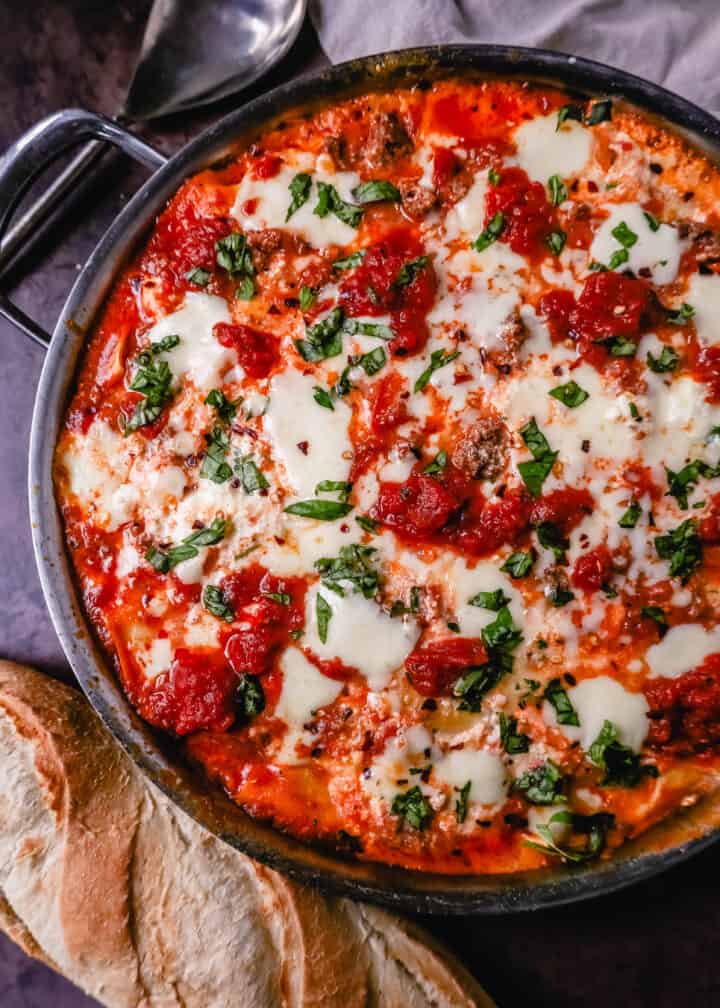 Quick, easy Skillet Lasagna made in 35 minutes is filled with bolognese meat sauce, ricotta parmesan cheese filling, mozzarella cheese, and fresh herbs. This is the best skillet lasagna recipe!