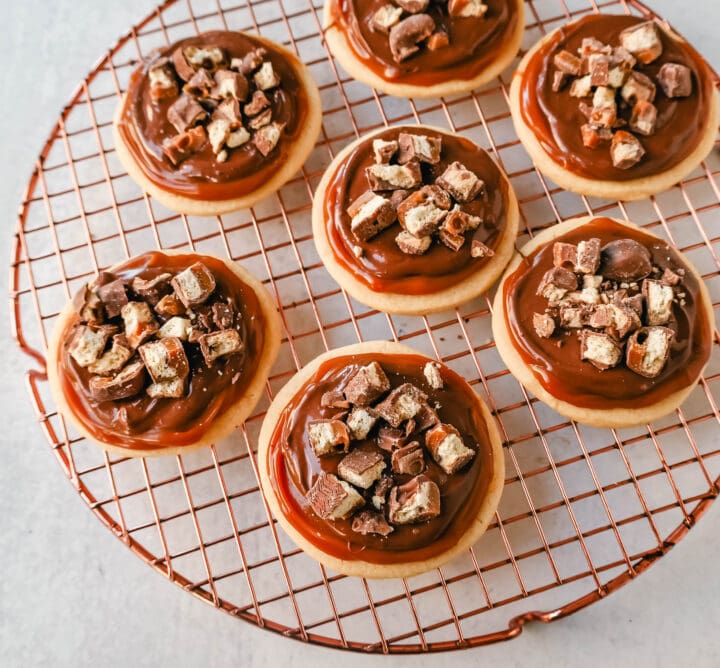 Twix Cookies made with soft sugar shortbread topped with rich caramel and milk chocolate and sprinkled with chopped Twix candy bars. These Millionaire Cookies are the best chocolate caramel shortbread cookie!