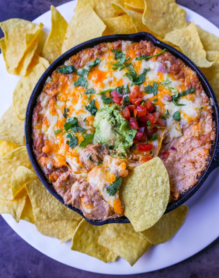 This is the best bean dip recipe ever! This is such an easy bean and cheese dip made with creamy beans, sour cream, cream cheese, taco seasoning, hot sauce, and lots of Mexican cheese! This easy bean dip is the best appetizer recipe. 