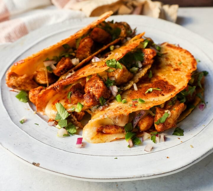 Chipotle Spiced Chicken Tacos with a cheese-filled tortilla and topped with fresh salsa. These easy chicken tacos are made in less than 20 minutes and are so popular!