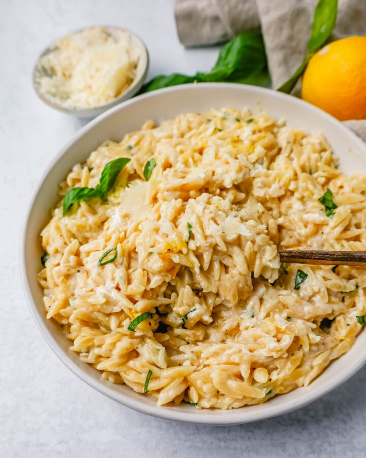 This easy Creamy Lemon Orzo is a rich, creamy dish with bright lemon and fresh basil. This one-pan creamy lemon orzo is made in only 20 minutes! It is the perfect side dish or served alongside grilled chicken or steak.