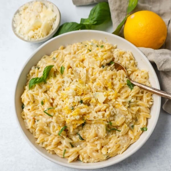 This easy Creamy Lemon Orzo is a rich, creamy dish with bright lemon and fresh basil. This one-pan creamy lemon orzo is made in only 20 minutes! It is the perfect side dish or served alongside grilled chicken or steak.