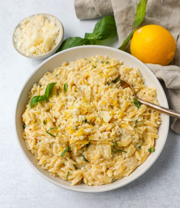 This easy Creamy Lemon Orzo is a rich, creamy dish with bright lemon and fresh basil. This one-pan creamy lemon orzo is made in only 20 minutes! It is the perfect side dish or served alongside grilled chicken or steak.