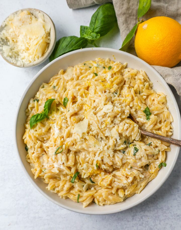 This easy Creamy Lemon Orzo is a rich, creamy dish with bright lemon and fresh basil. This one-pan creamy lemon orzo is made in only 20 minutes! It is the perfect side dish or served alongside grilled chicken or steak.