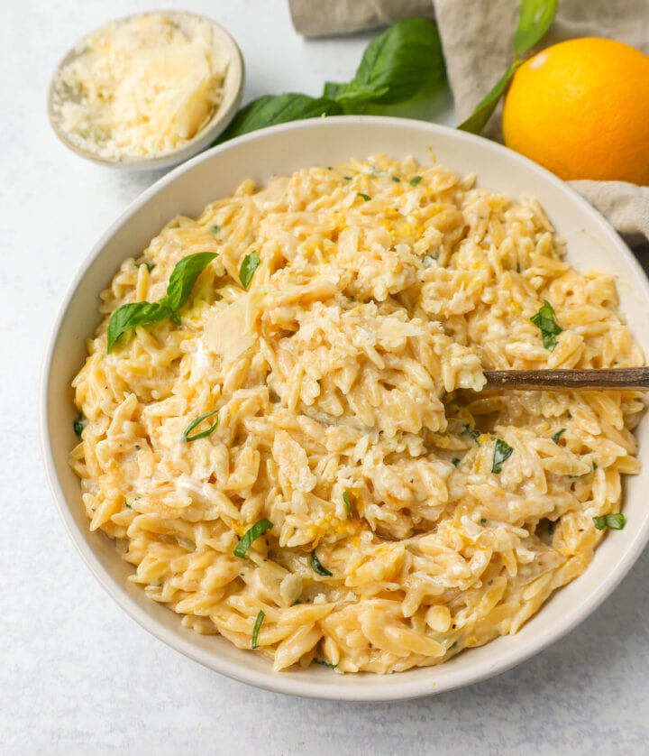 This easy Creamy Lemon Orzo is a rich, creamy dish with bright lemon and fresh basil. This one-pan creamy lemon orzo is made in only 20 minutes! It is the perfect side dish or served alongside grilled chicken or steak.