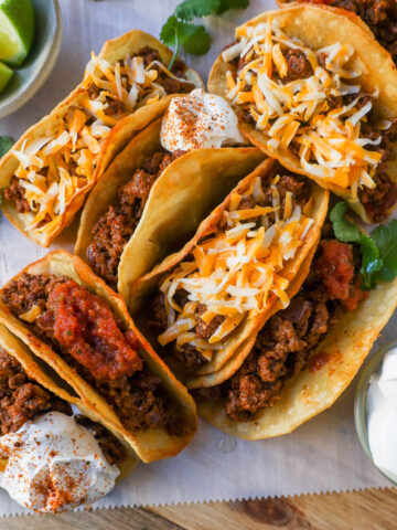 These homemade Ground Beef Tacos are made with spiced taco meat loaded into fried taco shells. Top with your favorite toppings for an easy 30-minute meal!