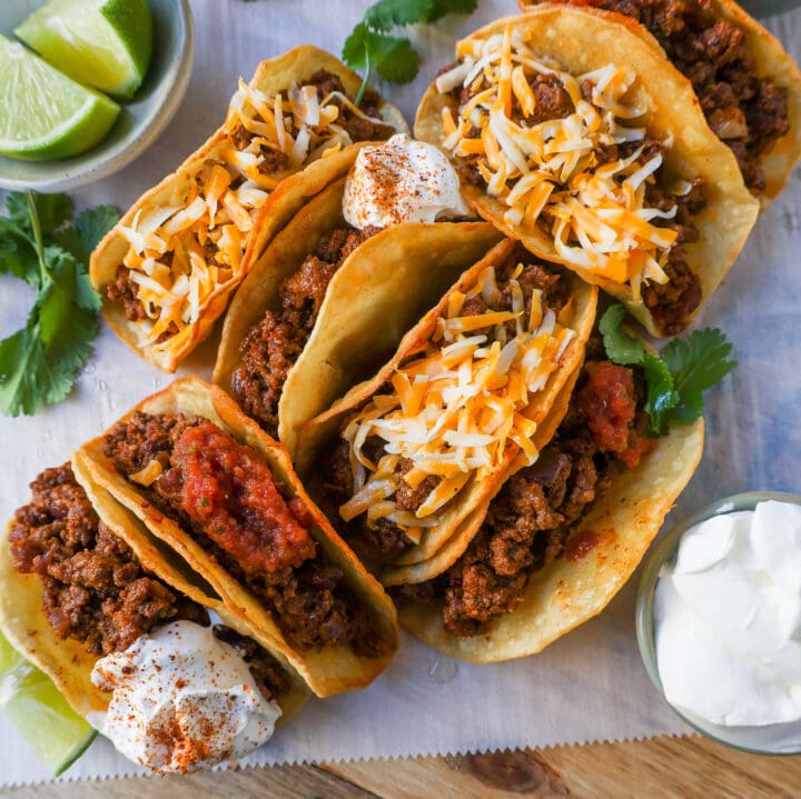 These homemade Ground Beef Tacos are made with spiced taco meat loaded into fried taco shells. Top with your favorite toppings for an easy 30-minute meal!