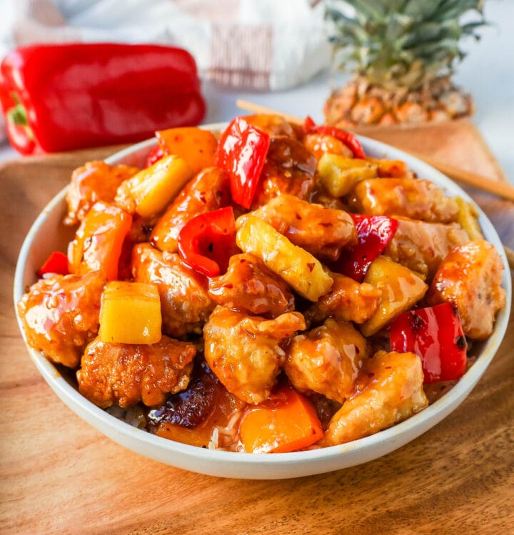 Sweet and Sour Chicken is made with crispy fried chicken covered in a pineapple sweet and sour sauce. The ultimate Sweet and Sour Chicken Recipe is way better than take-out.  