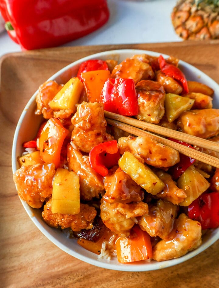 Sweet and Sour Chicken is made with crispy fried chicken covered in a pineapple sweet and sour sauce. The ultimate Sweet and Sour Chicken Recipe is way better than take-out.  