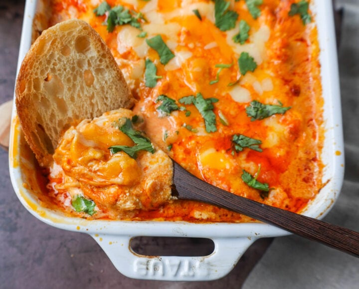 This Hot Creamy Buffalo Chip Dip is made with tender shredded chicken, cream cheese, buffalo sauce, ranch dressing, and topped with cheese, and baked until warm and bubbly.