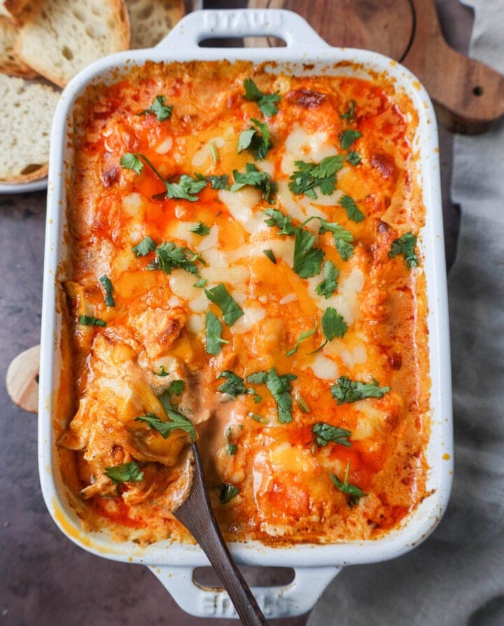 This Hot Creamy Buffalo Chip Dip is made with tender shredded chicken, cream cheese, buffalo sauce, ranch dressing, and topped with cheese, and baked until warm and bubbly.