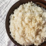 This Coconut Rice recipe is made with only five ingredients -- rice, coconut milk, water, sugar, and salt. It is the perfect savory side dish with a touch of coconut flavor.