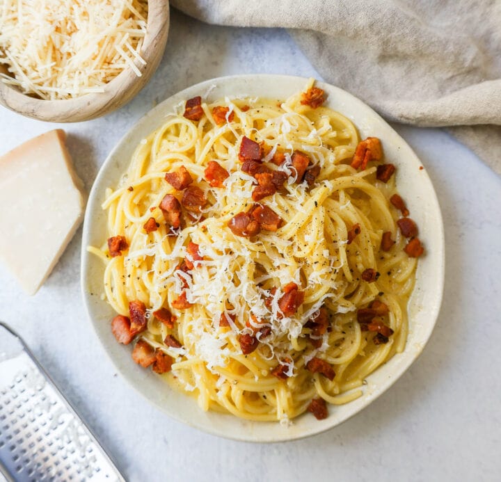 How to make the best spaghetti carbonara from scratch with only five ingredients. This homemade carbonara is made with nutty parmigiano reggiano cheese, pancetta, spaghetti, creamy egg yolks, and black pepper. This Italian carbonara is famous for good reason!