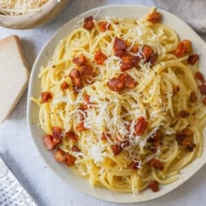 How to make the best spaghetti carbonara from scratch with only five ingredients. This homemade carbonara is made with nutty parmigiano reggiano cheese, pancetta, spaghetti, creamy egg yolks, and black pepper. This Italian carbonara is famous for good reason!