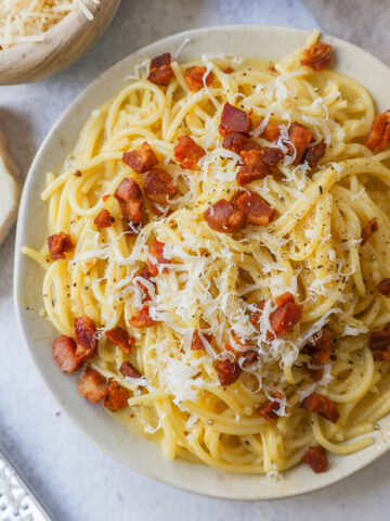 How to make the best spaghetti carbonara from scratch with only five ingredients. This homemade carbonara is made with nutty parmigiano reggiano cheese, pancetta, spaghetti, creamy egg yolks, and black pepper. This Italian carbonara is famous for good reason!