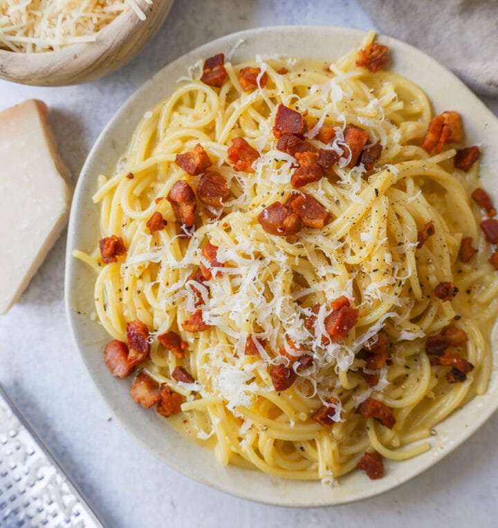 How to make the best spaghetti carbonara from scratch with only five ingredients. This homemade carbonara is made with nutty parmigiano reggiano cheese, pancetta, spaghetti, creamy egg yolks, and black pepper. This Italian carbonara is famous for good reason!