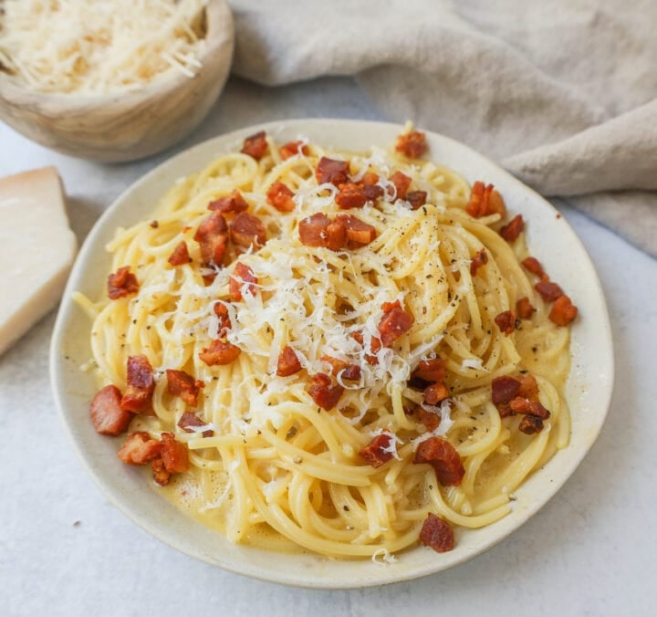 How to make the best spaghetti carbonara from scratch with only five ingredients. This homemade carbonara is made with nutty parmigiano reggiano cheese, pancetta, spaghetti, creamy egg yolks, and black pepper. This Italian carbonara is famous for good reason!