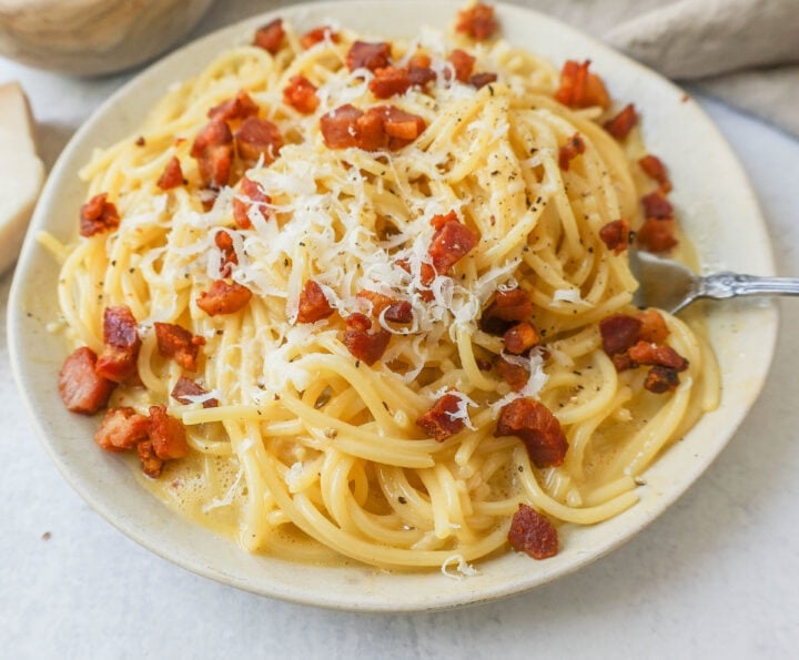 How to make the best spaghetti carbonara from scratch with only five ingredients. This homemade carbonara is made with nutty parmigiano reggiano cheese, pancetta, spaghetti, creamy egg yolks, and black pepper. This Italian carbonara is famous for good reason!