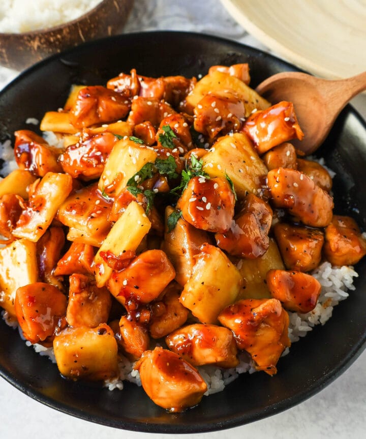This Sticky Pineapple Chicken is made with chicken tossed in pineapple juice, sweet chili sauce, soy sauce, brown sugar, ginger, and fresh pineapple. This Hawaiian Chicken is perfectly sweet and sticky! 