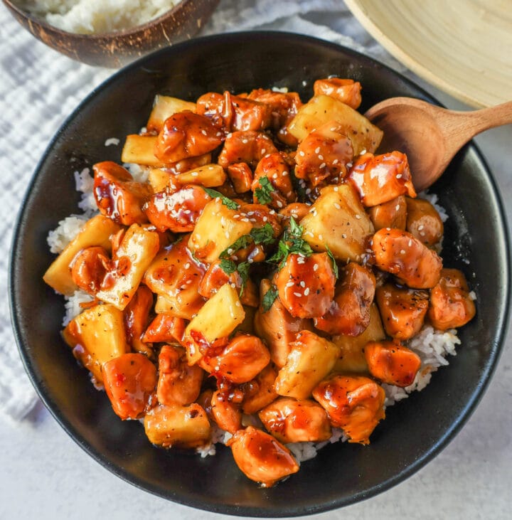 This Sticky Pineapple Chicken is made with chicken tossed in pineapple juice, sweet chili sauce, soy sauce, brown sugar, ginger, and fresh pineapple. This Hawaiian Chicken is perfectly sweet and sticky! 