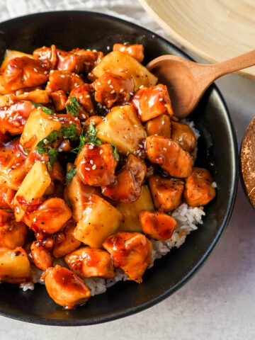 This Sticky Pineapple Chicken is made with chicken tossed in pineapple juice, sweet chili sauce, soy sauce, brown sugar, ginger, and fresh pineapple. This Hawaiian Chicken is perfectly sweet and sticky! 