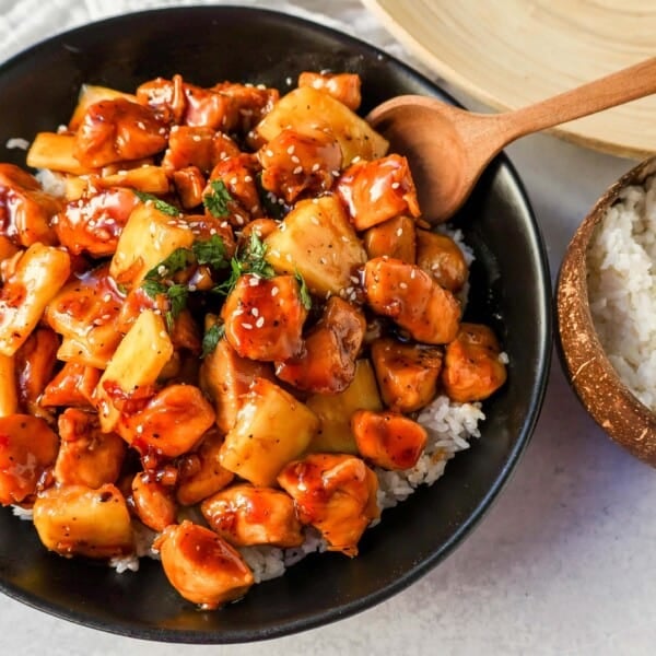 This Sticky Pineapple Chicken is made with chicken tossed in pineapple juice, sweet chili sauce, soy sauce, brown sugar, ginger, and fresh pineapple. This Hawaiian Chicken is perfectly sweet and sticky! 