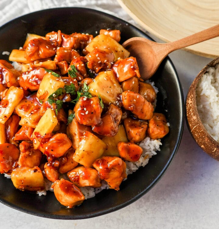 This Sticky Pineapple Chicken is made with chicken tossed in pineapple juice, sweet chili sauce, soy sauce, brown sugar, ginger, and fresh pineapple. This Hawaiian Chicken is perfectly sweet and sticky! 