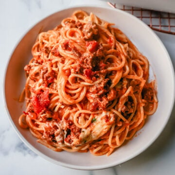This Famous TikTok Million Dollar Spaghetti is made with a marinara meat sauce mixed with homemade alfredo sauce, tossed with spaghetti noodles, and baked with mozzarella cheese until bubbly. It is the best baked spaghetti recipe!