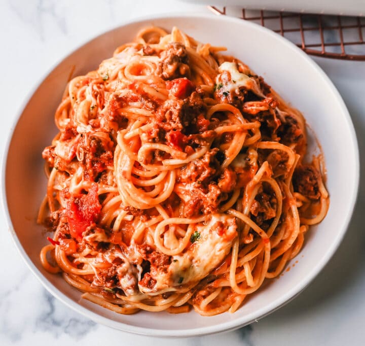 This Famous TikTok Million Dollar Spaghetti is made with a marinara meat sauce mixed with homemade alfredo sauce, tossed with spaghetti noodles, and baked with mozzarella cheese until bubbly. It is the best baked spaghetti recipe!