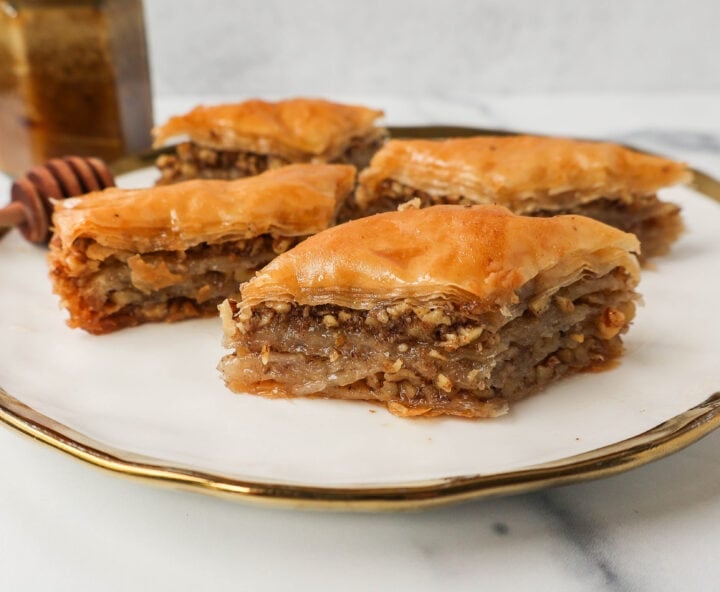 This is the best Baklava recipe made with layers of crisp, flaky, and buttery phyllo dough with crunchy cinnamon walnuts and soaked in sweet honey syrup. This is the most popular Greek dessert for good reason. Here are step-by-step instructions for making homemade Greek Baklava.