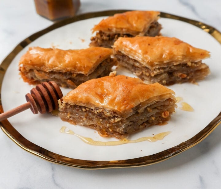 This is the best Baklava recipe made with layers of crisp, flaky, and buttery phyllo dough with crunchy cinnamon walnuts and soaked in sweet honey syrup. This is the most popular Greek dessert for good reason. Here are step-by-step instructions for making homemade Greek Baklava.