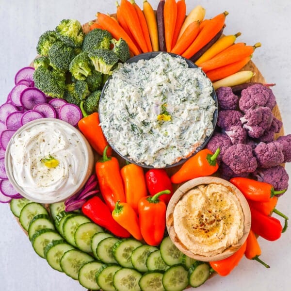 How to make a beautiful Crudite Platter with vegetables and dips. I am sharing my favorite veggie dip recipes, what vegetables to put on a veggie tray, and how to arrange one. It is so easy to make a stunning vegetable platter!