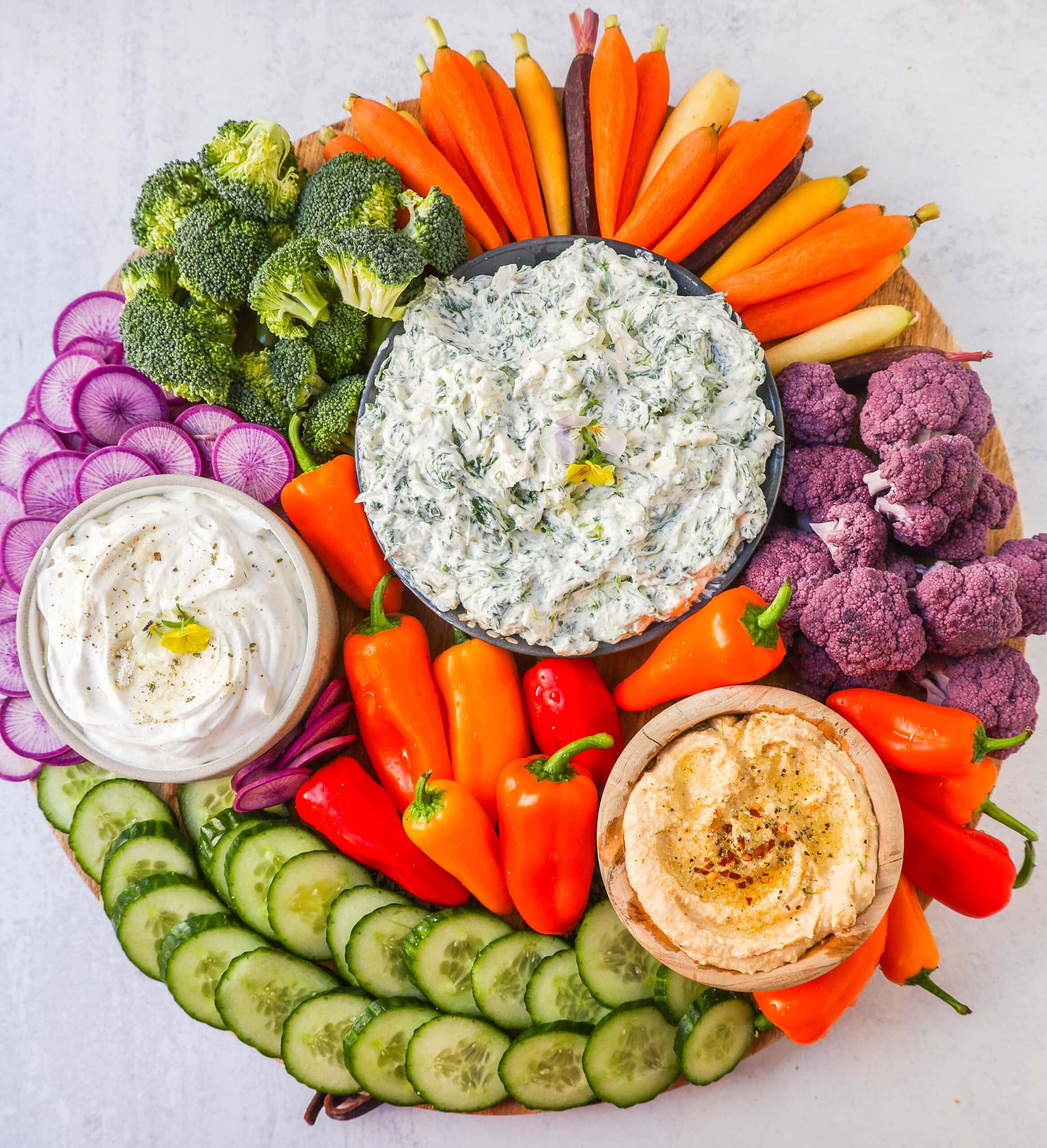 How to make a beautiful Crudite Platter with vegetables and dips. I am sharing my favorite veggie dip recipes, what vegetables to put on a veggie tray, and how to arrange one. It is so easy to make a stunning vegetable platter!