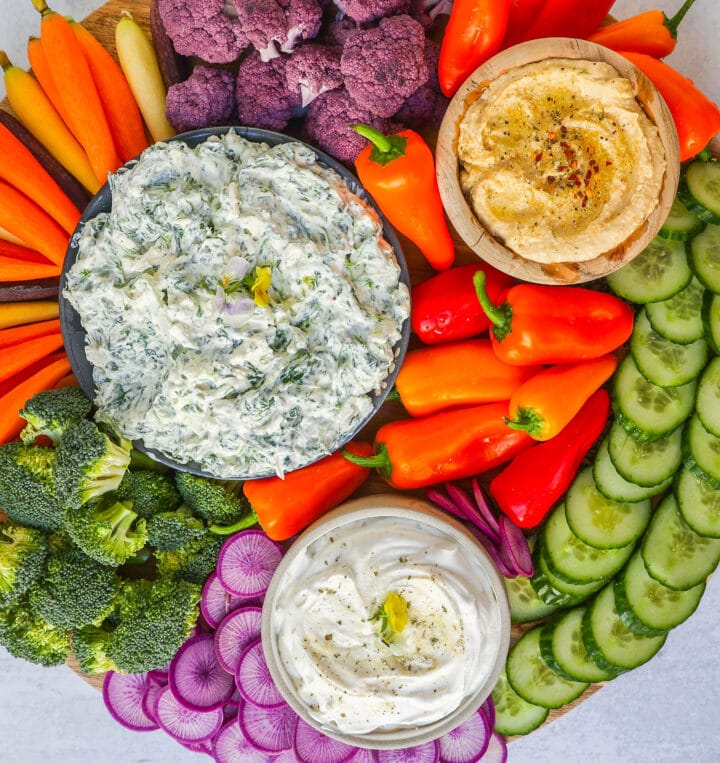 How to make a beautiful Crudite Platter with vegetables and dips. I am sharing my favorite veggie dip recipes, what vegetables to put on a veggie tray, and how to arrange one. It is so easy to make a stunning vegetable platter!